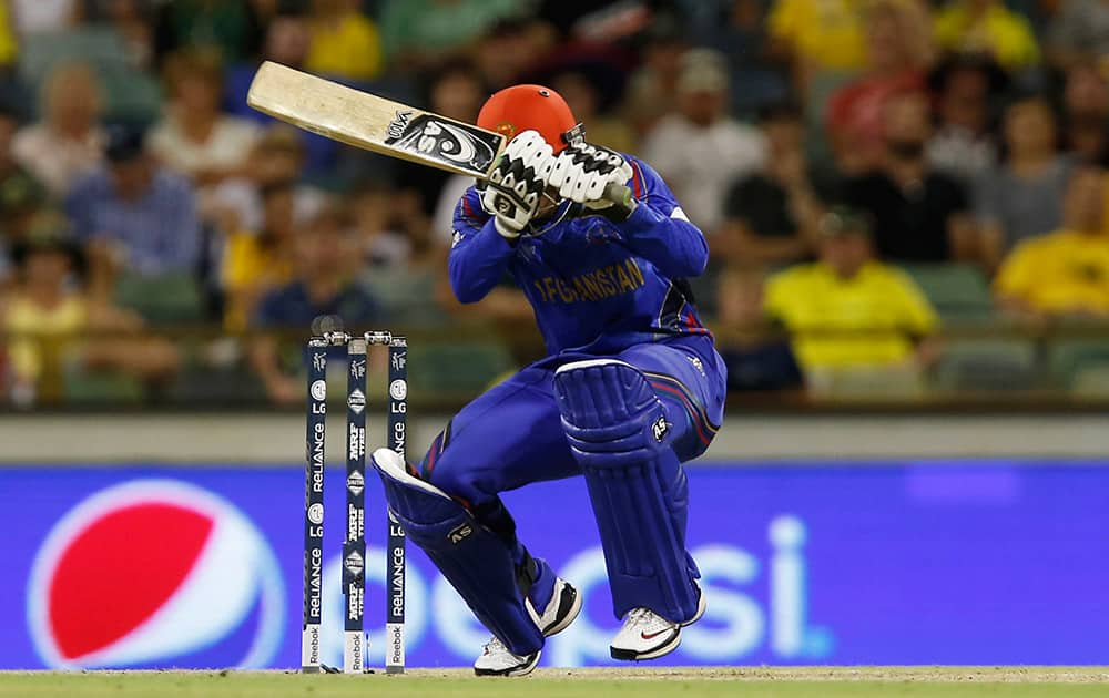 Afghanistan’s Usman Ghani ducks to avoid a bouncer during their Cricket World Cup Pool A match against Australia in Perth, Australia.