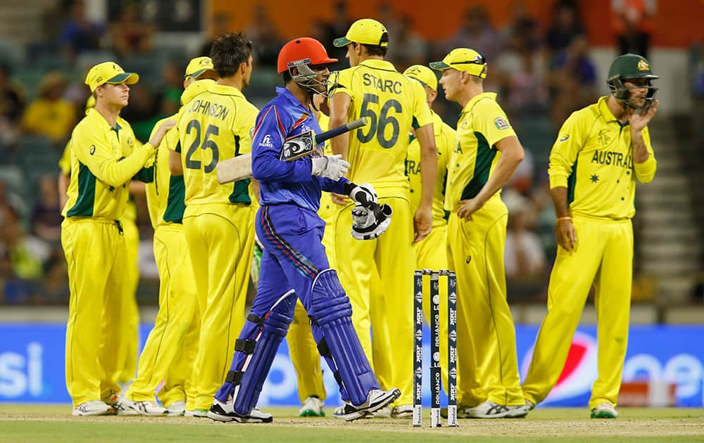 Afghanistan’s Usman Ghani walks back towards the pavilion after being dismissed during their Cricket World Cup Pool A match against Australia in Perth, Australia.