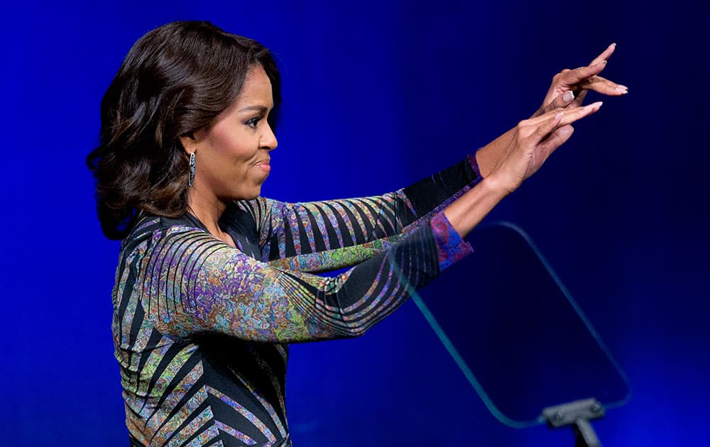 First lady Michelle Obama waves while speaking at the Newseum in Washington, to launch the 