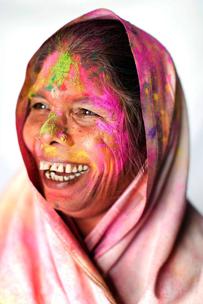 Hindu widow Uma, 65, poses for a portrait after celebrating Holi, the Hindu festival of colors, at the Meera Sahabhagini Widow Ashram in Vrindavan, India.