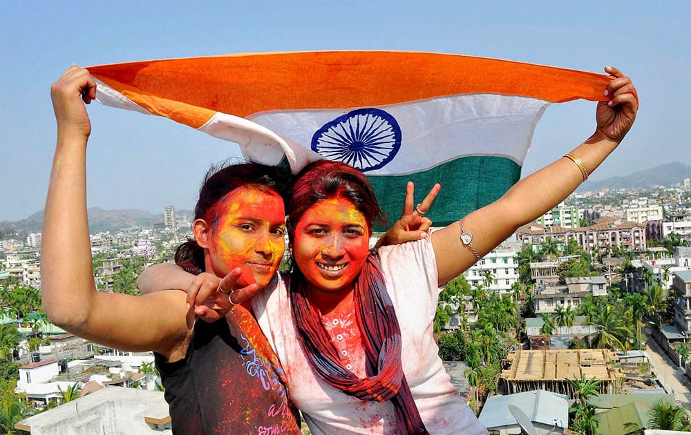 Girls cheers for Indian cricket team with Holi colours and a Tricolour on the eve of the teams match against West Indies, in Guwahati.