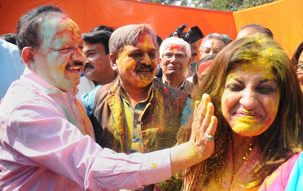 Union Science and Technology Minister Harsh Vardhan celebrates Holi with Delhi BJP President Satish Upadhyay and party leader Shazia Ilmi at the party office in New Delhi.