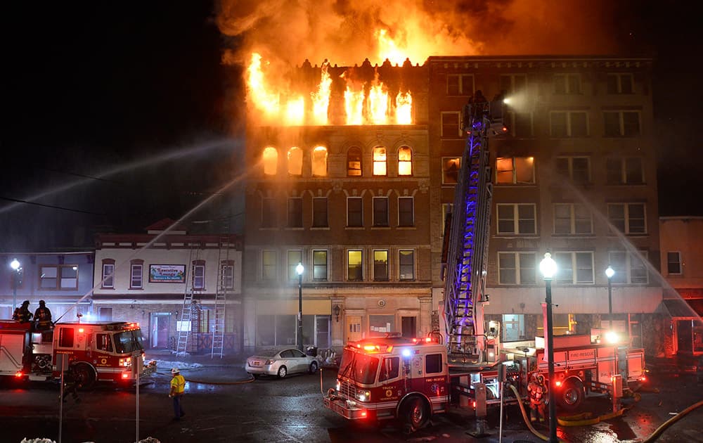 Schenectady firefighters battle a blaze that gutted two five-story apartment buildings in Schenectady, N.Y.