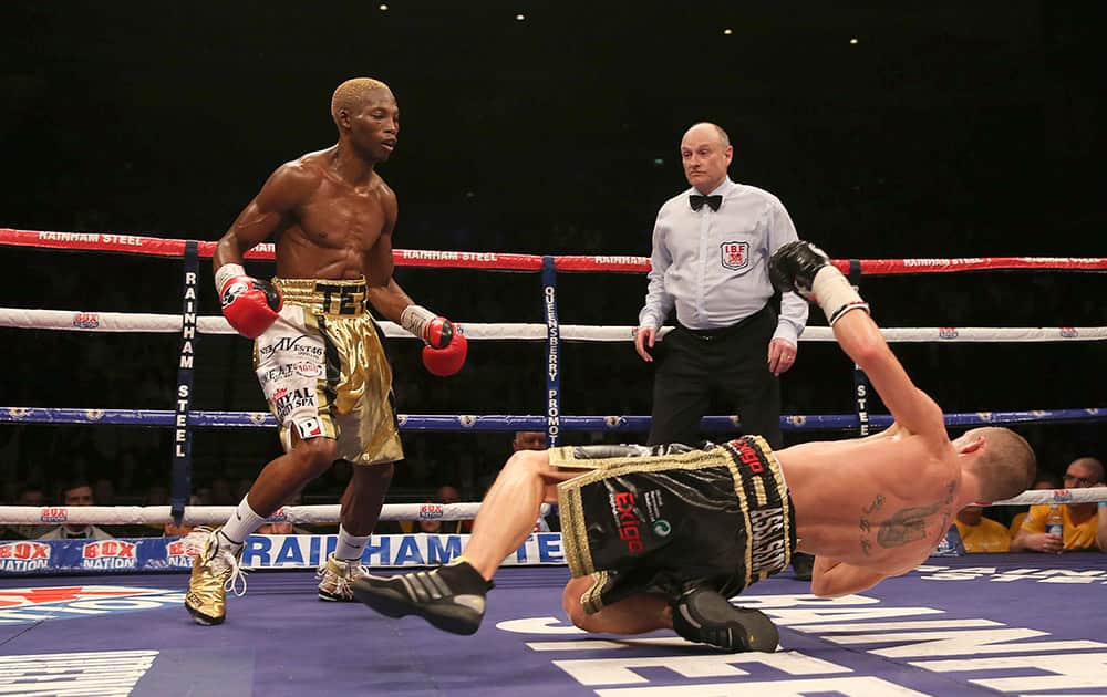 Zolani Tete of South Africa knocks down Paul Butler in their IBF Super-Flyweight Championship of the World fight at the Echo Arena, Liverpool, England.