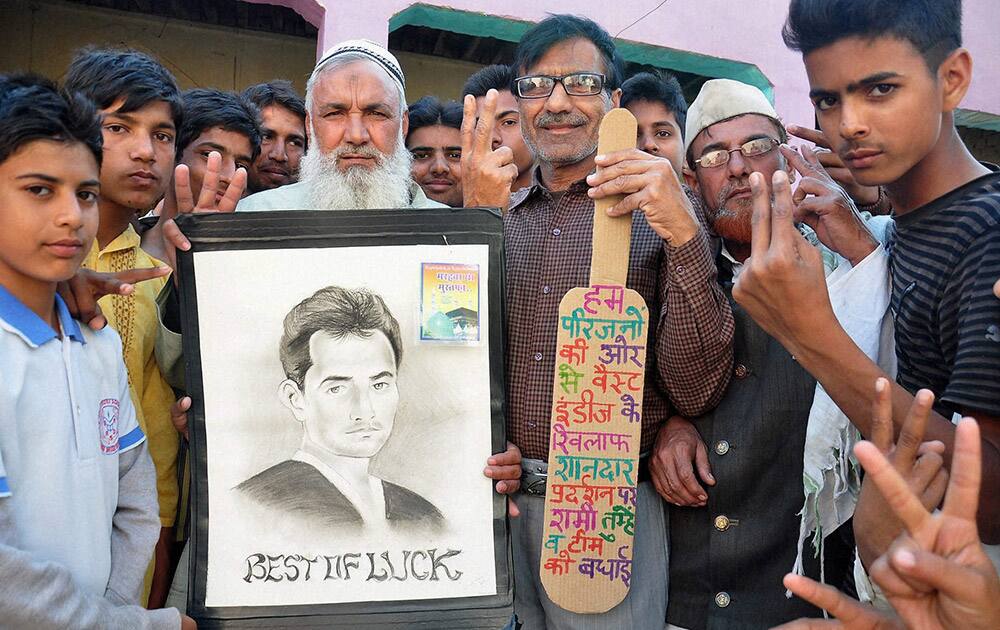 Family members and supporters of Indian cricketer Mohammad Shami celebrate Indias victory over West Indies in World Cup, in Moradabad.