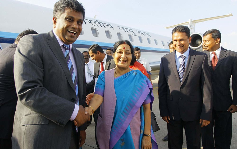 Indian Foreign Minister Sushma Swaraj shakes hand with Sri Lankan Deputy Foreign Minister Ajith Perera upon her arrival in Colombo, Sri Lanka.