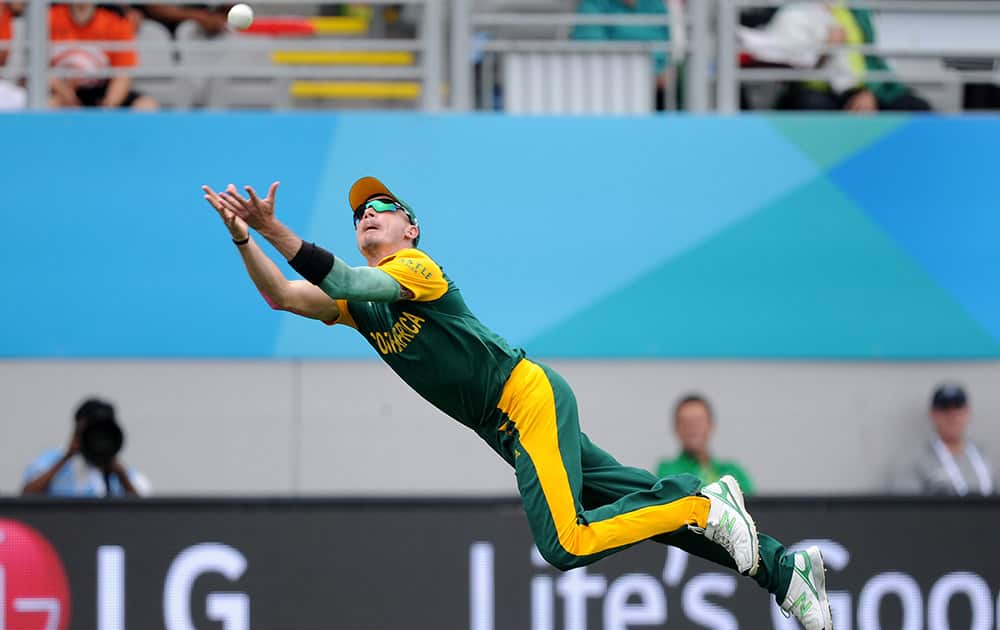South Africa's Dale Steyn is airborne as he dives to take a catch to dismiss Pakistan batsman Ahmad Shahzad during their Cricket World Cup Pool B match in Auckland, New Zealand.