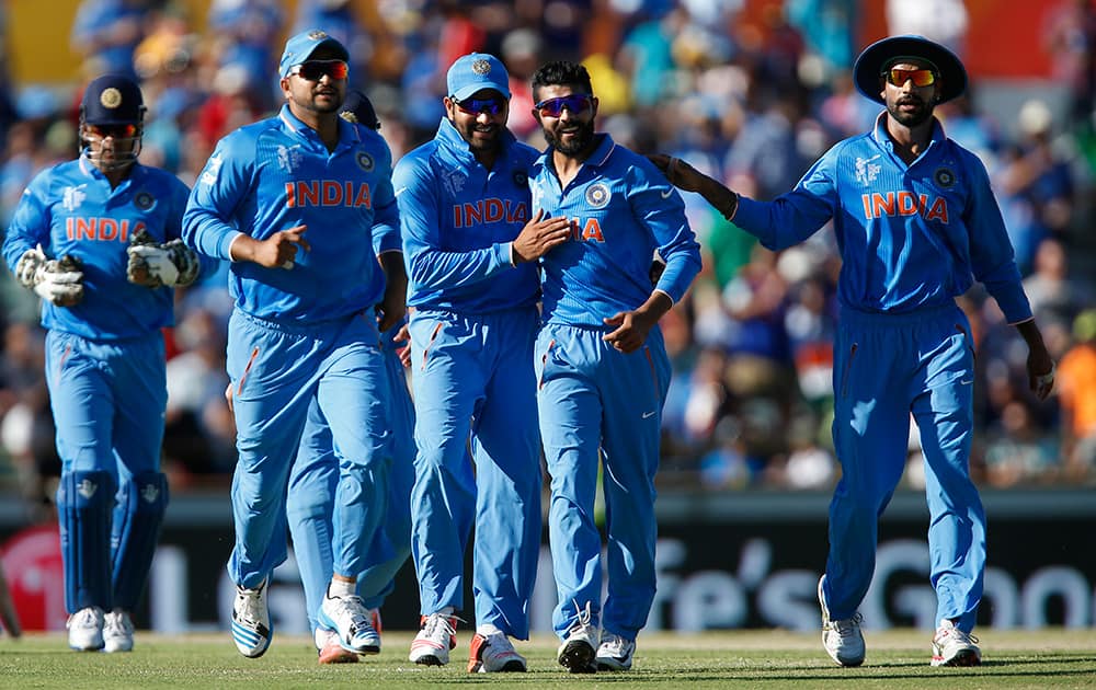 Ravindra Jadeja is congratulated by teammates after dismissing West Indies batsman Andre Russell during their Cricket World Cup Pool B match in Perth, Australia.