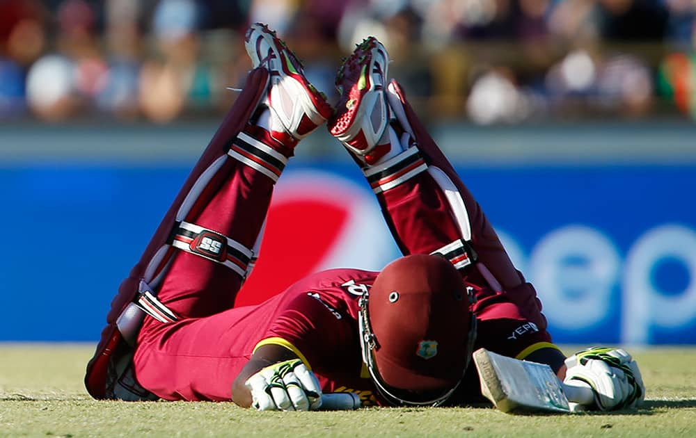 West Indies baseman Jason Holder lies on the ground after diving to make his ground during their Cricket World Cup Pool B match against India in Perth, Australia.