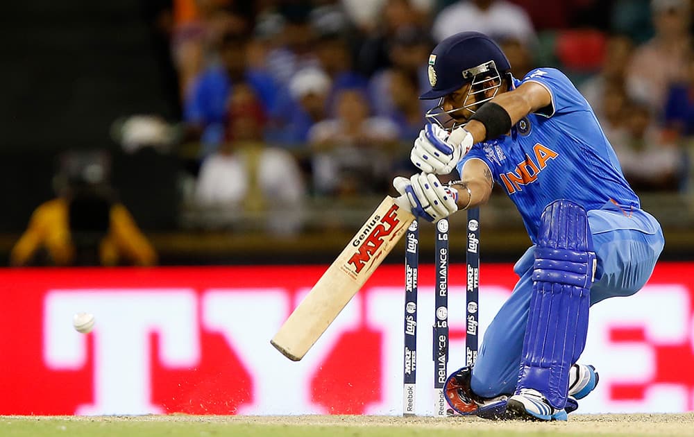 Virat Kohli hits the ball while batting against the West Indies during their Cricket World Cup Pool B match in Perth, Australia.