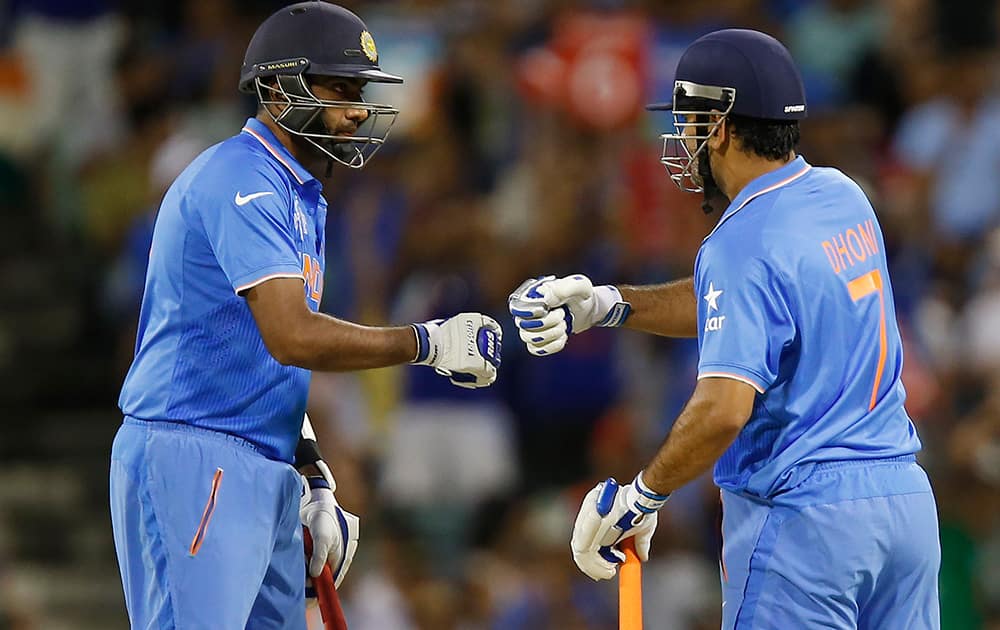 M S Dhoni and teammate Ravichandran Ashwin talk during their Cricket World Cup Pool B match against the West Indies in Perth, Australia.