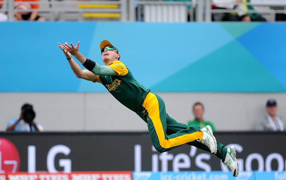 South Africa's Dale Steyn is airborne as he dives to take a catch to dismiss Pakistan batsman Ahmad Shahzad during their Cricket World Cup Pool B match in Auckland, New Zealand.