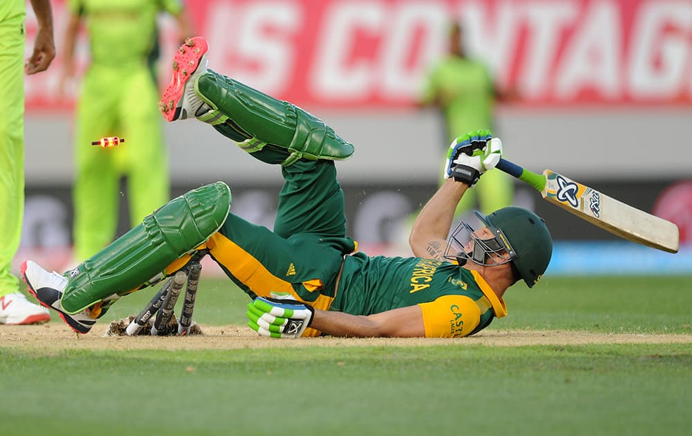 South African batsman Francois Du Plessis rolls on the ground after diving to make his ground while batting against Pakistan during their Cricket World Cup Pool B match in Auckland, New Zealand.