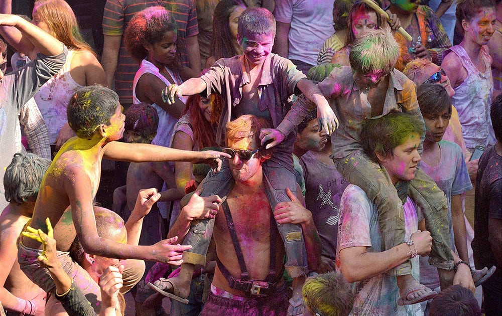 Foreign tourists take part in Holi celebration in Pushkar, Rajasthan.