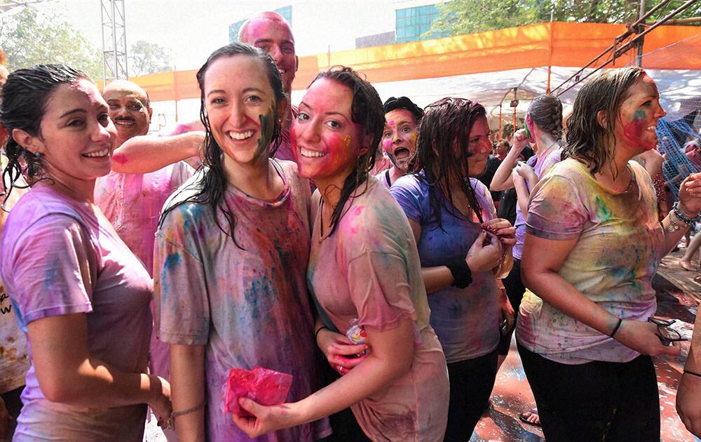 Foreigners along with locals celebrate Holi festival in Mumbai.