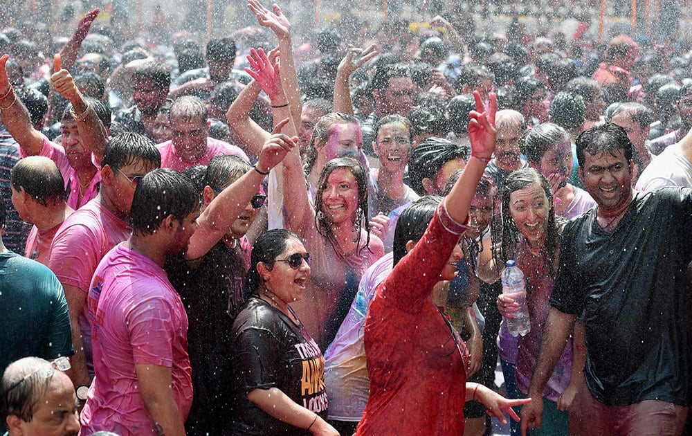 Foreigners along with locals celebrate Holi festival in Mumbai.