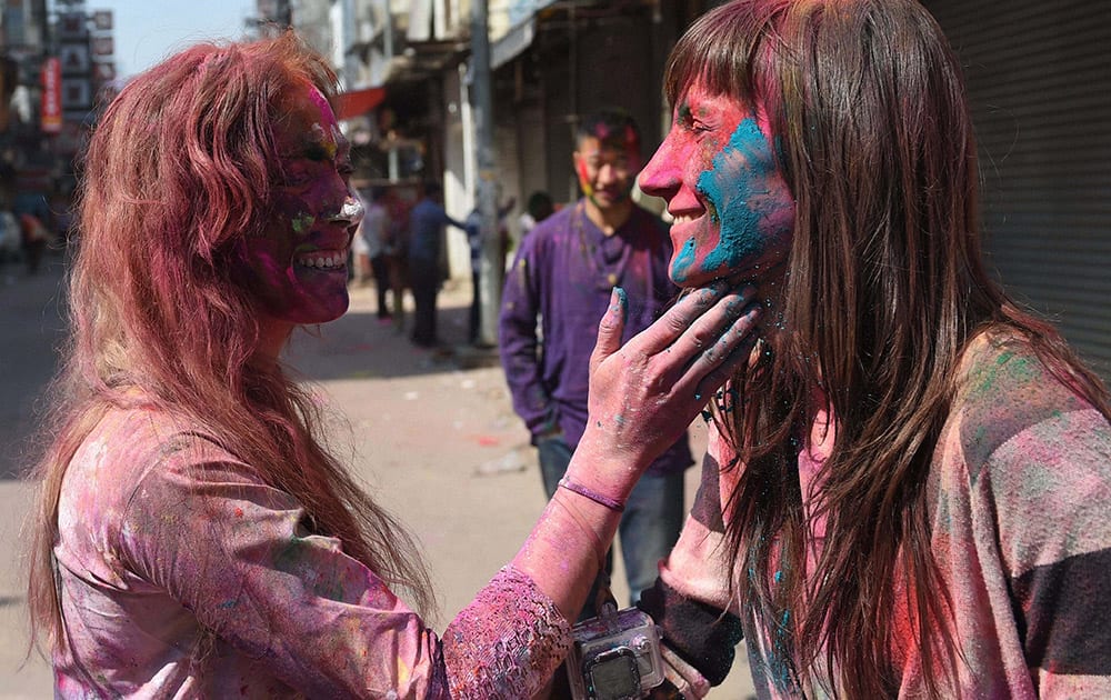 Foreigners celebrate Holi at Paharganj in New Delhi.