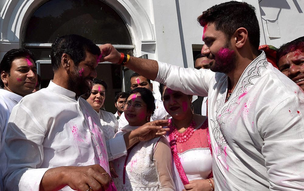 Lok Janshakti Party president Ram Vilas Paswan with his wife and son Chirag Paswan celebrating Holi at his residence in New Delhi.