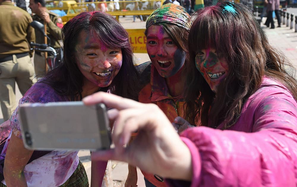 Foreigners celebrate Holi at Paharganj in New Delhi.