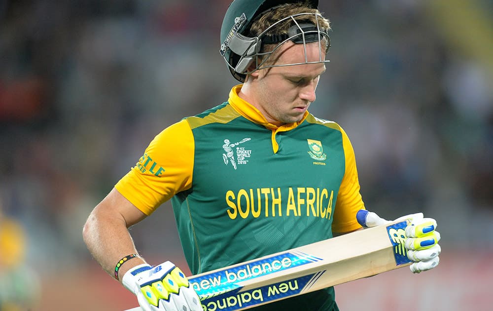 South African batsman David Miller looks at his bat as he leaves the field after he was dismissed for no score by Pakistan bowler Rahat Ali during their Cricket World Cup Pool B match in Auckland, New Zealand.