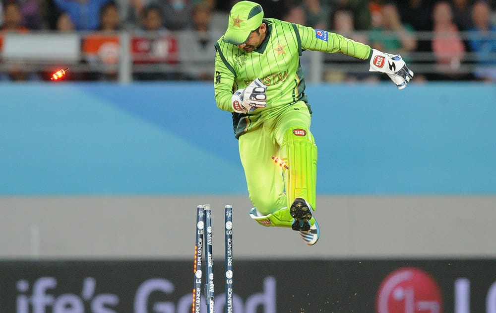 Pakistan wicketkeeper Sarfraz Ahmed knocks the bails off as he celebrates the dismissal of South Africa's A.B de Villiers during their Cricket World Cup Pool B match in Auckland, New Zealand.