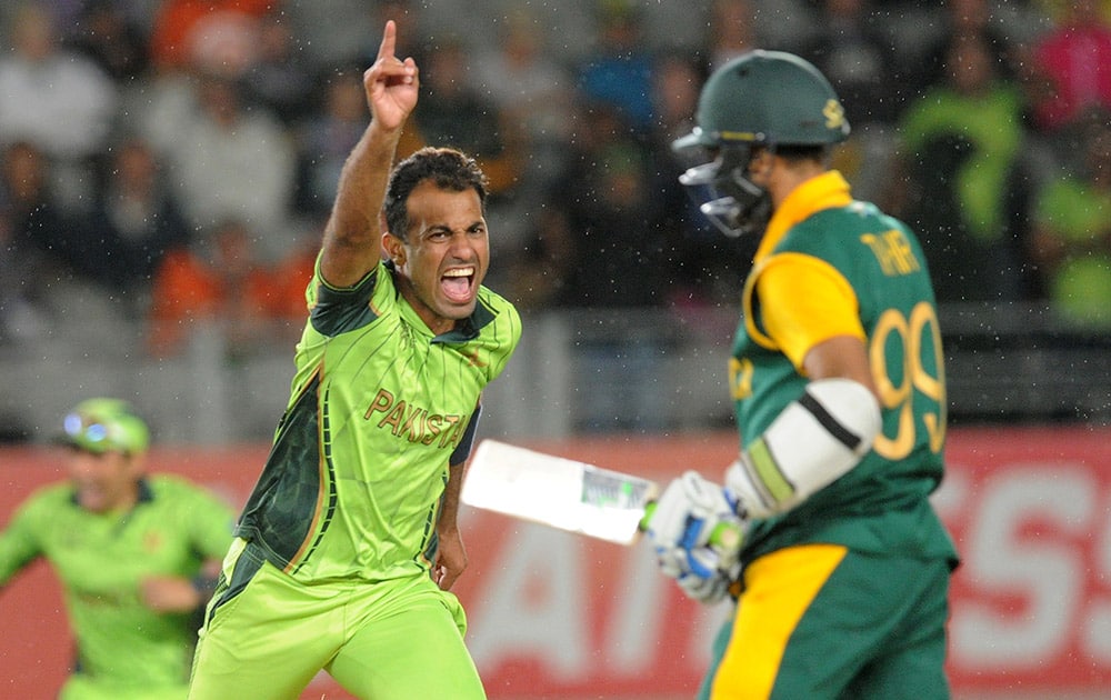 Pakistan's Wahab Riaz runs as he celebrate's the dismissal of South Africa's Muhammad Imran Tahir and their 29 run win over South Africa in their Cricket World Cup Pool B match in Auckland, New Zealand.