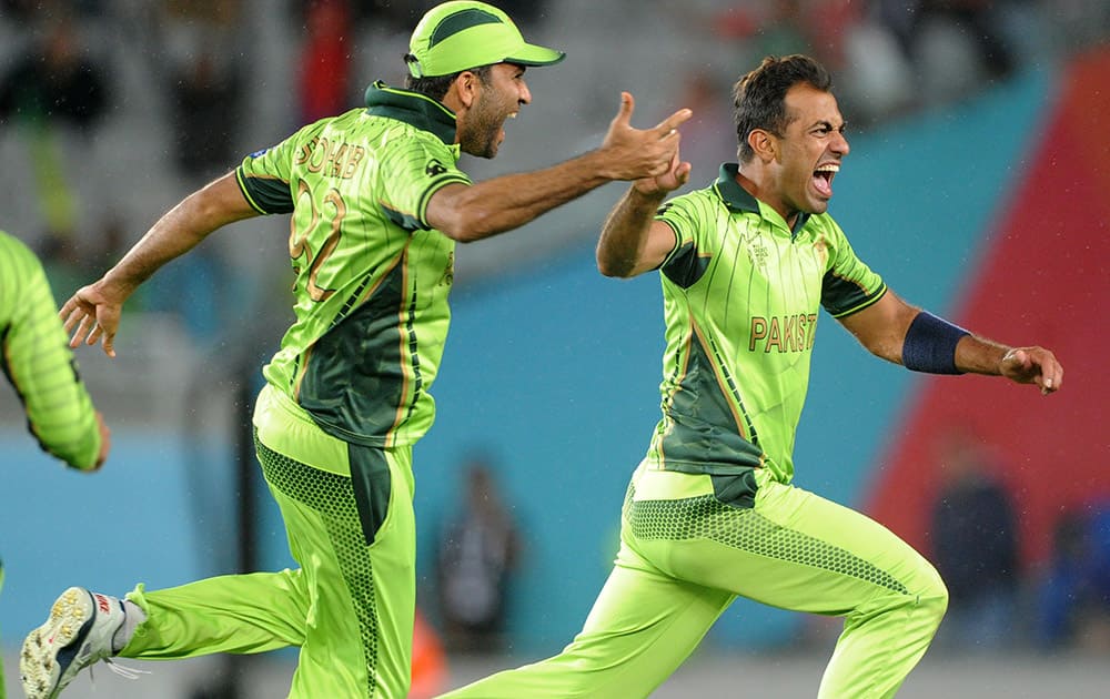 Pakistan's Wahab Riaz celebrates with teammate Sohail Khan as they celebrate their 29 run win over South Africa in their Cricket World Cup Pool B match in Auckland, New Zealand.