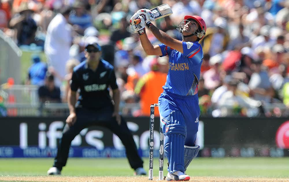 Afghanistan’s Najib Zadran watches as he plays a shot while batting against New Zealand during their Cricket World Cup Pool A match in Napier, New Zealand.