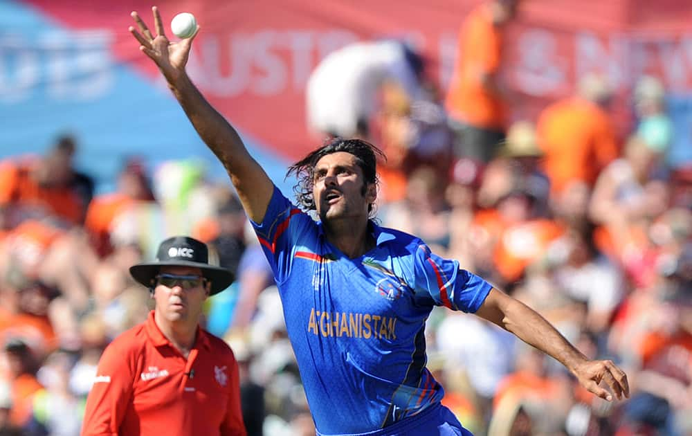 Afghanistan’s Shapoor Zadran reaches out to stop the ball during their Cricket World Cup Pool A match against New Zealand in Napier, New Zealand.