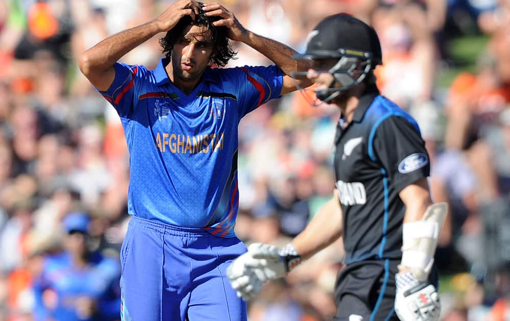 Afghanistan bowler Shapoor Zadran, left, reacts after dismissing New Zealand’s Kane Williamson, right, during their Cricket World Cup Pool A match in Napier, New Zealand.