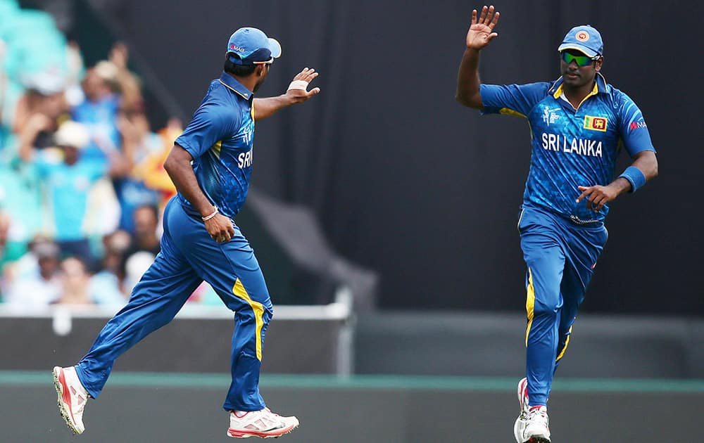 Sri Lanka's Angelo Mathews, right, celebrates with teammate Seekkuge Prasanna after the dismissal of Australian batsman David Warner during their Cricket World Cup Pool A match in Sydney, Australia.