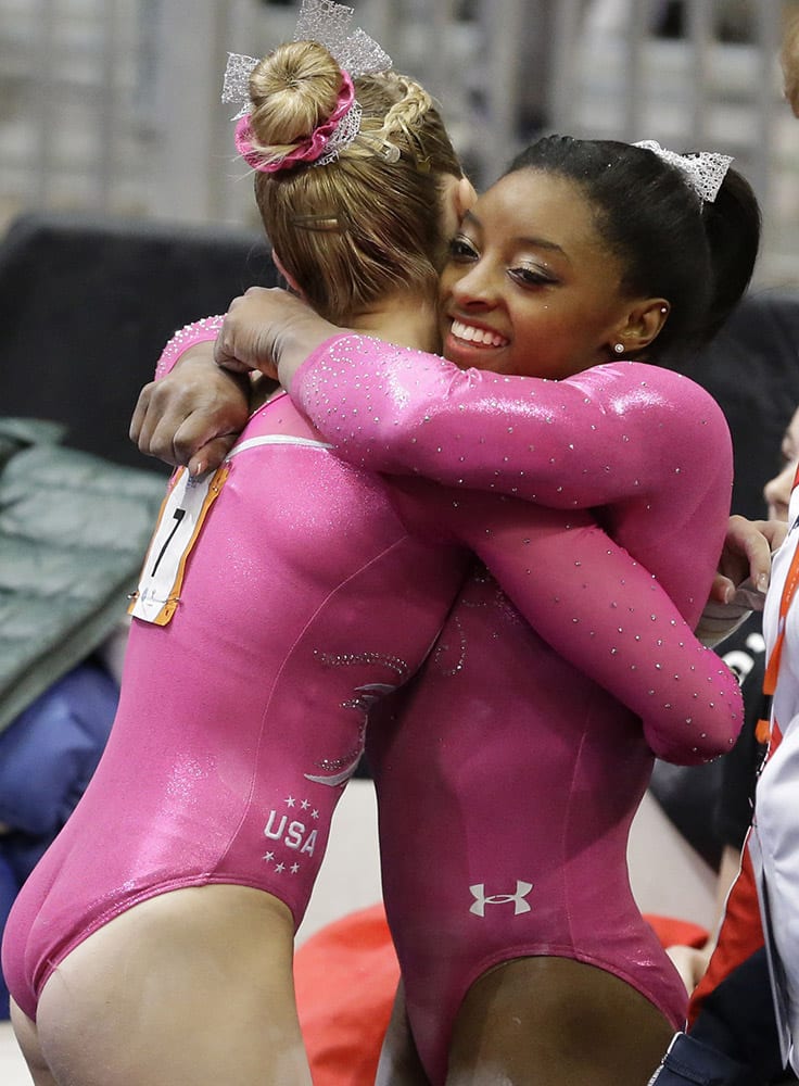 Simone Biles, right, hugs MyKayla Skinner after an event during the American Cup gymnastics competition in Arlington, Texas.