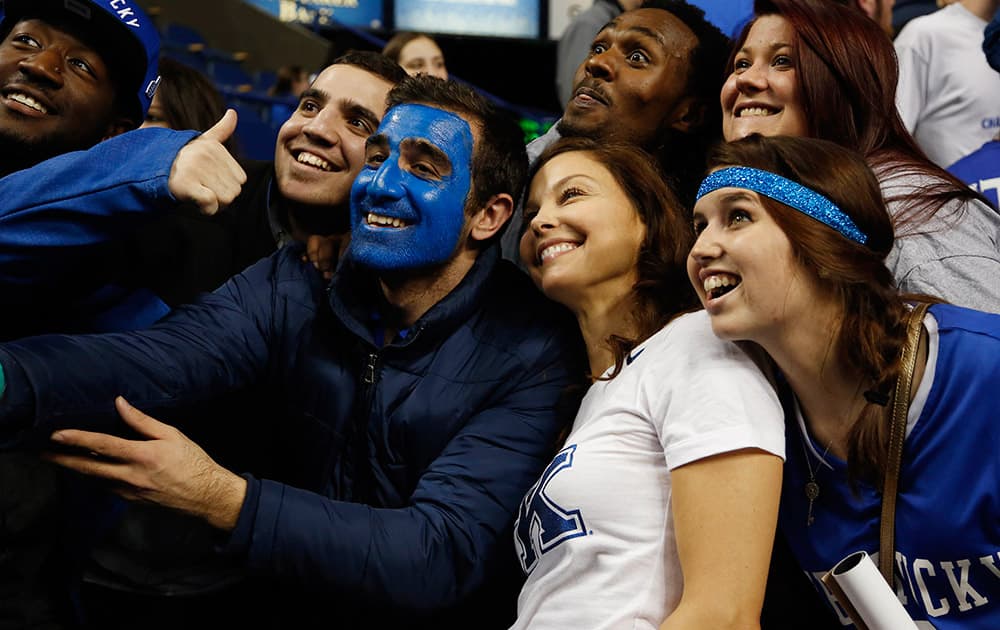 Actress Ashley Judd, second from right, poses with Kentucky fans after an NCAA college basketball game between Kentucky and Florida, in Lexington, Ky. Kentucky won 67-50. 