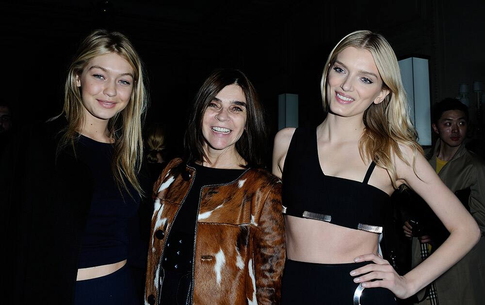 Gigi Hadid, left, Carine Roitfeld, center, and Lily Donaldson pose while they attend the Samsung S6 Party, at the Georges V Hotel, during the Paris Fashion week.