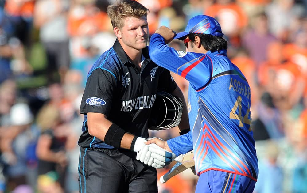 New Zealand batsman Corey Anderson, left, shakes hands with Afghanistan’s Asghar Stanikzai following their six wicket win in their Cricket World Cup Pool A match in Napier, New Zealand.