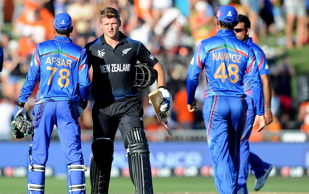 New Zealand batsman Corey Anderson, centre, is congratulated by Afghanistan’s Afsar Zazai and Nawroz Mangal, right, following their six wicket win in their Cricket World Cup Pool A match in Napier, New Zealand.