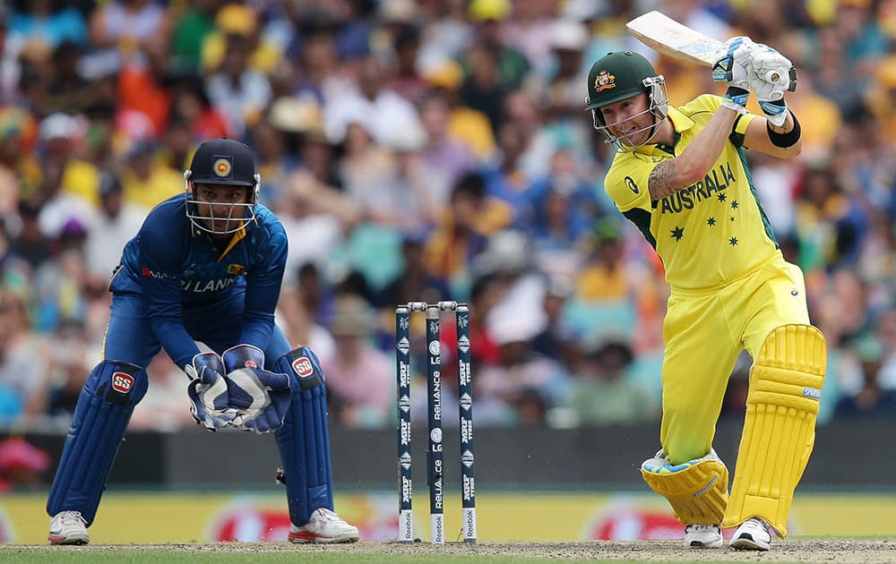 Australian batsman Michael Clarke plays a shot as Sri Lanka's Kumar Sangakkara watches during their Cricket World Cup Pool A match in Sydney, Australia.