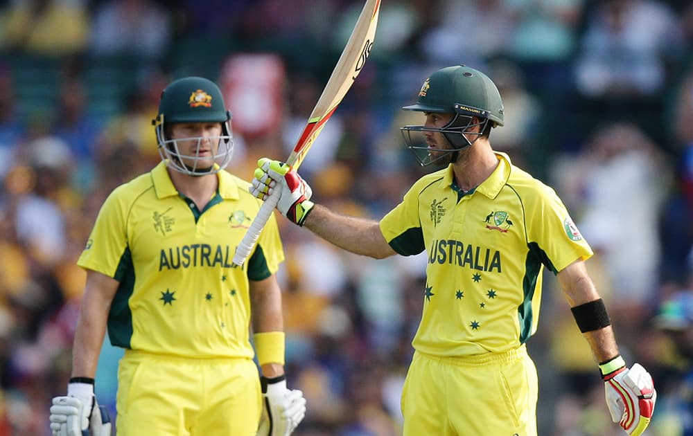 Australian batsman Glenn Maxwell waves to the crowd after scoring 50 runs as teammate Shane Watson watches during their Cricket World Cup Pool A match against Sri Lanka in Sydney, Australia.