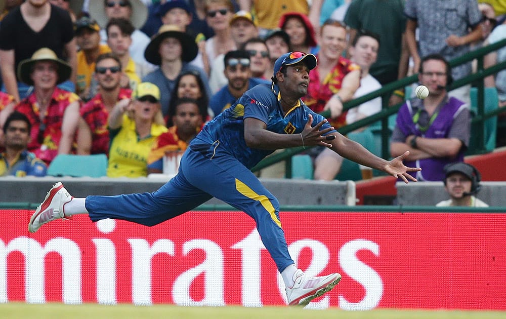 Sri Lanka's Thisara Perera attempts to take a catch during their Cricket World Cup Pool A match against Australia in Sydney, Australia.