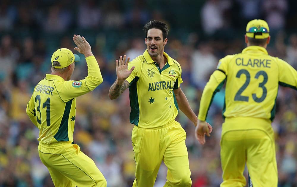 Australia’s Mitchell Johnson, center, celebrates the wicket of Sri Lanka’s Lahiru Thirimanne, during their Cricket World Cup Pool A match in Sydney, Australia.