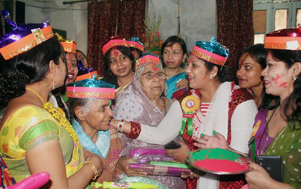 Women celebrate with colours at an old age home on the occasion of International Womens Day in Varanasi.