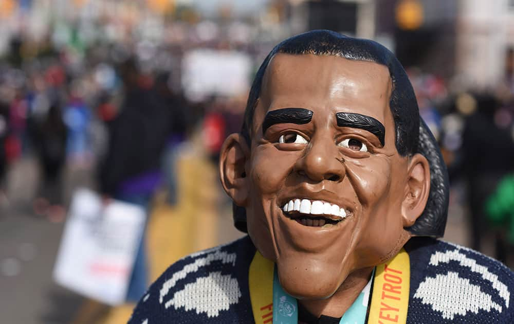 R Jesus McNair of Detroit, walks on the Edmund Pettus Bridge with his President Barack Obama mask, in Selma, Ala.