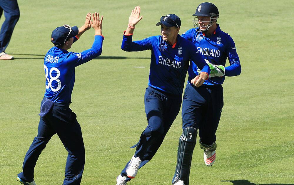 England's Joe Root, centre, is congratulated by teammates James Taylor, left, and Jos Butler after taking a catch to dismiss Bangladesh batsman Shakib Al Hasan during their Cricket World Cup Pool A match in Adelaide, Australia.