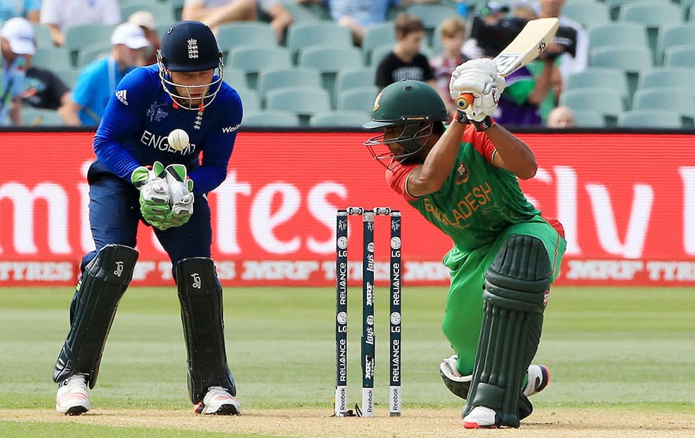 Bangladesh batsman Mahmudullah plays a shot as England wicketkeeper Jos Buttler watches during their Cricket World Cup Pool A match in Adelaide, Australia.