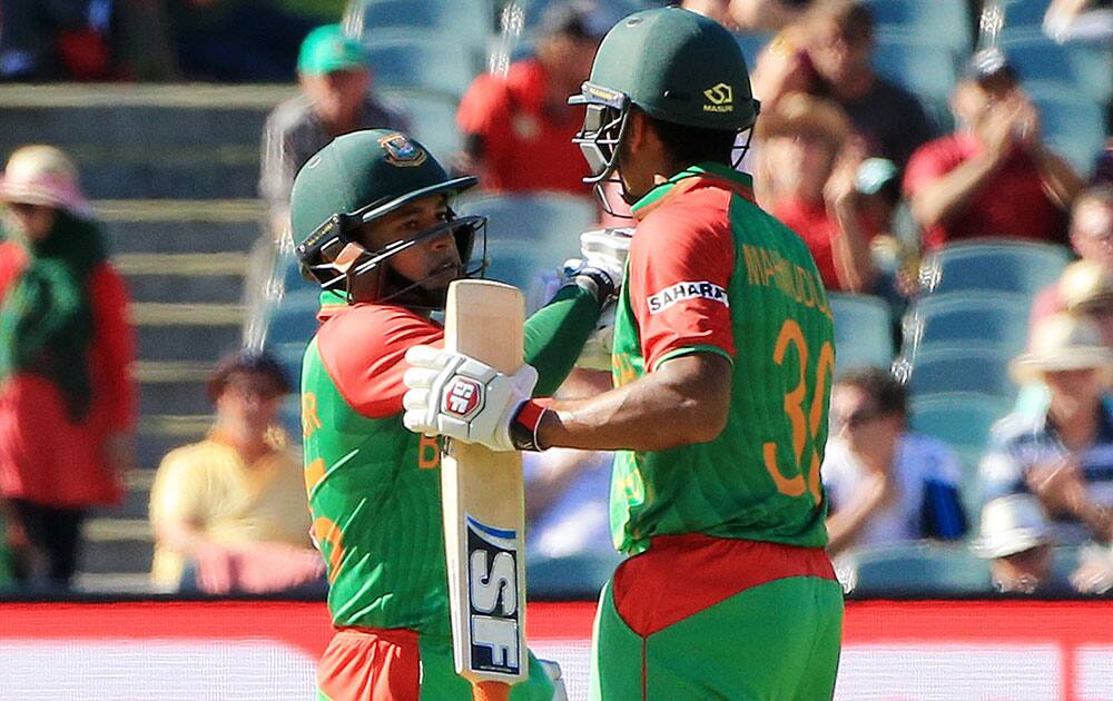 Bangladesh’s Mahmudullah, right, congratulates teammate Mushfiqur Rahim on his 50 runs during their Cricket World Cup Pool A match in Adelaide, Australia.