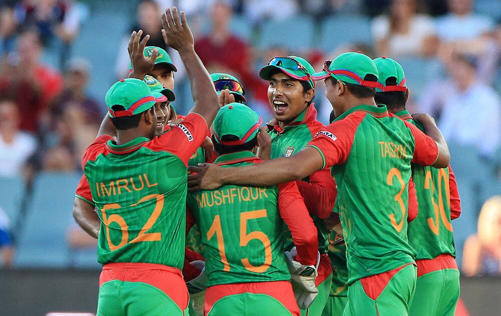 Bangladesh players celebrate after the run out of England batsman Moeen Ali during their Cricket World Cup Pool A match in Adelaide, Australia.