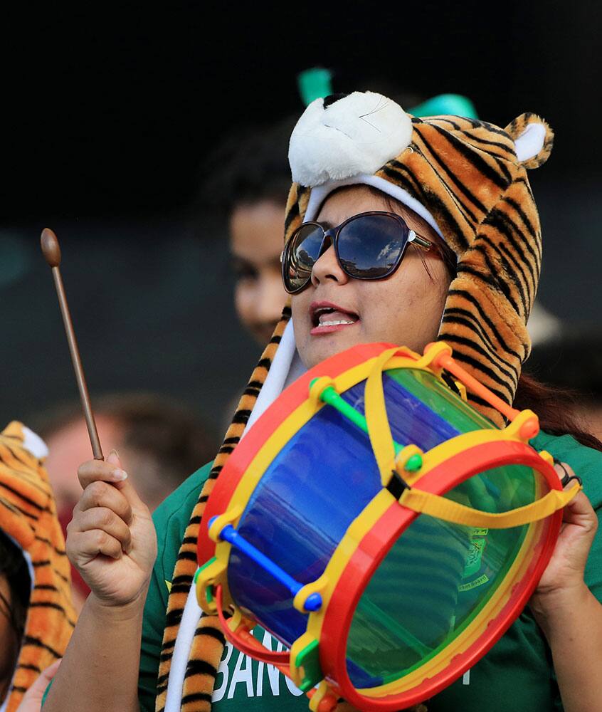 A supporter of the Bangladesh team plays a drum during their Cricket World Cup Pool A match against England in Adelaide, Australia.