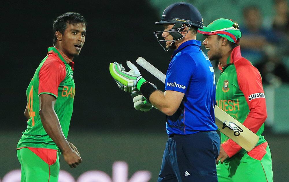 England's Ian Bell, second right, walks from the field after he was dismissed by Bangladesh bowler Rubel Hossain, left, during their Cricket World Cup Pool A match in Adelaide, Australia.