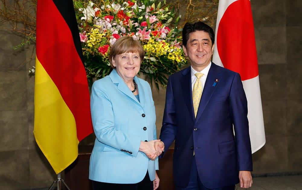 German Chancellor Angela Merkel and Japanese Prime Minister Shinzo Abe pose for photographers prior to a meeting at Abe's official residence in Tokyo.