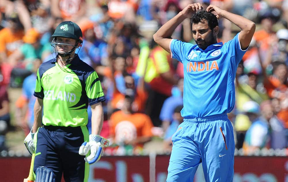 India's Mohammed Shami, right, reacts after bowling as Ireland's William Portfield watches during their Cricket World Cup Pool B match in Hamilton, New Zealand.